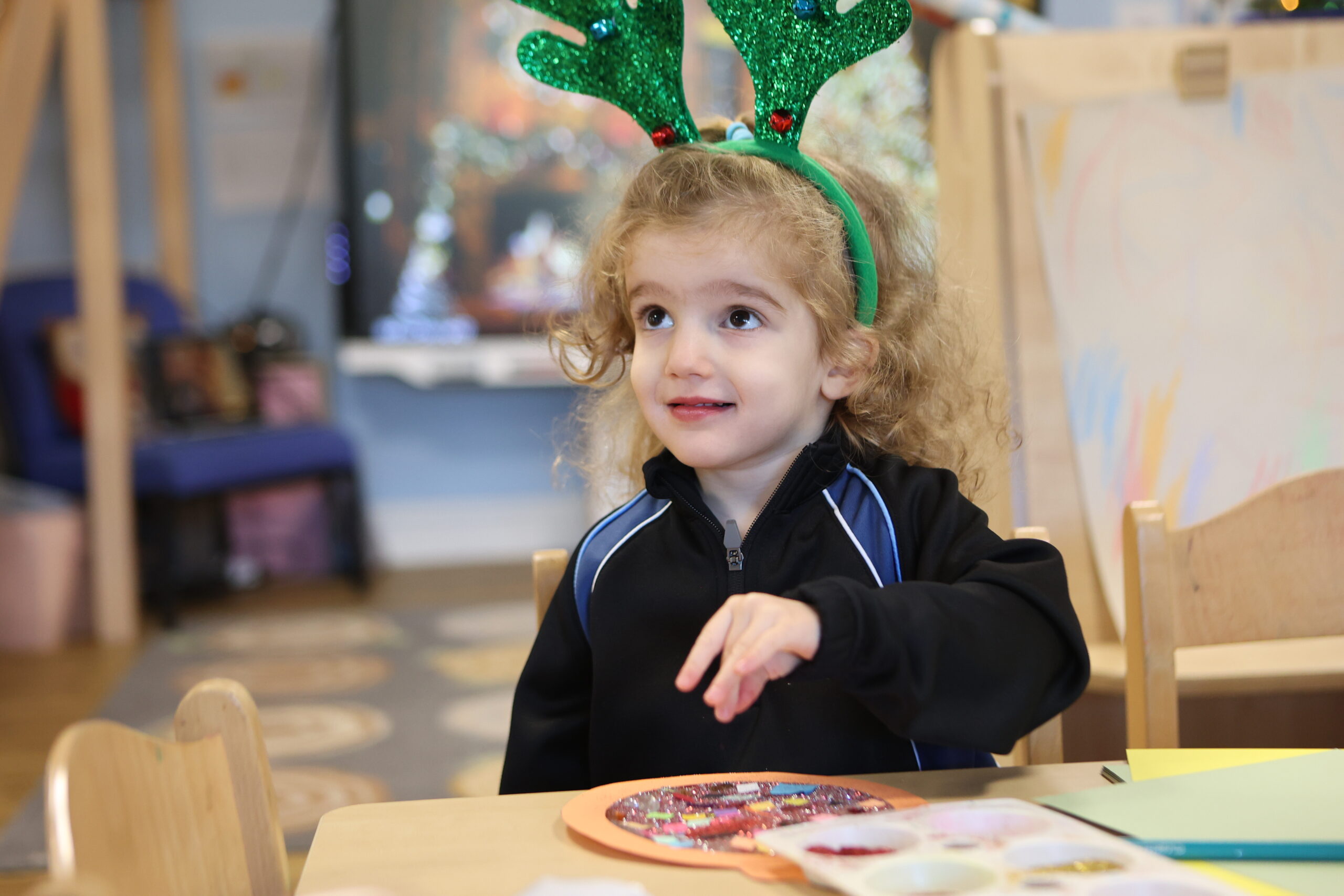 Nursery child at Crosfields School in Reading playing during the Christmas celebration. Festive learning at Nursery
